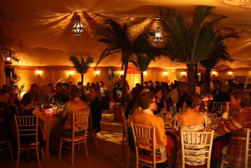A Silk Road theme birthday party, using warm, exotic lighting to enhance the theme